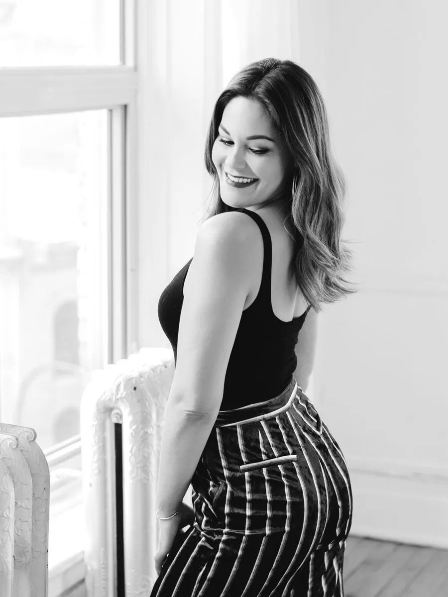 Bobbi Tanguay, dating coach, by a window in black and white